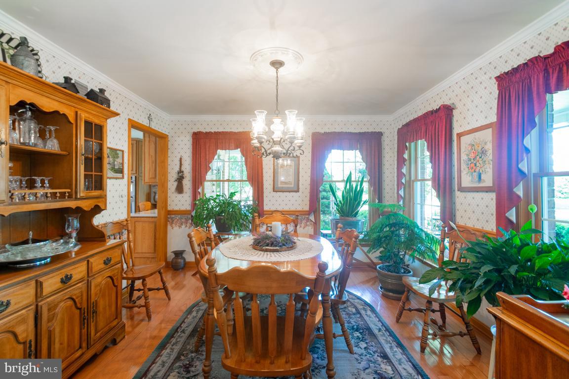 613 Hanover Pike Hampstead, MD 21074 - Photo 11 of 55 a view of a dining room with furniture window and wooden floor