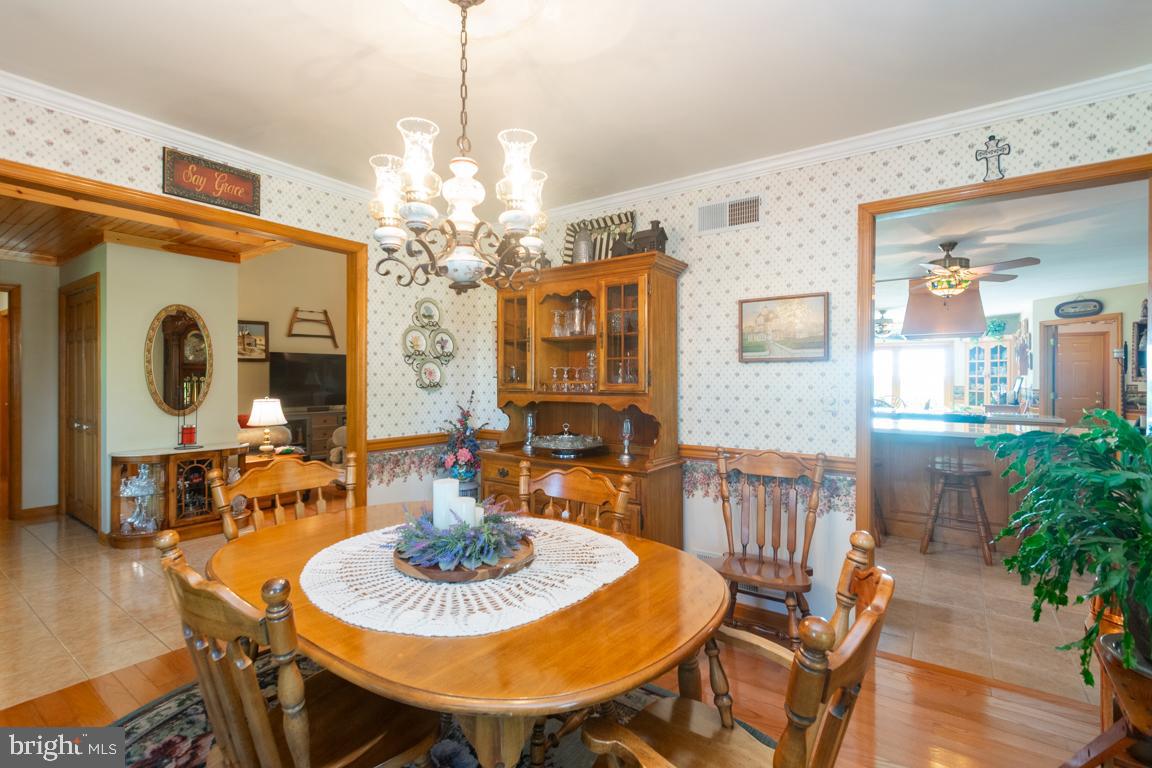 613 Hanover Pike Hampstead, MD 21074 - Photo 13 of 55 a view of a dining room with furniture and wooden floor