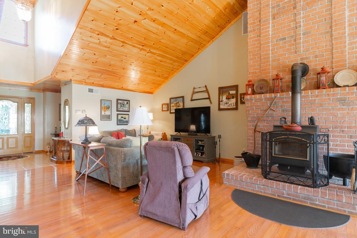 613 Hanover Pike Hampstead, MD 21074 - Photo 17 of 55 a living room with furniture a flat screen tv and a fireplace