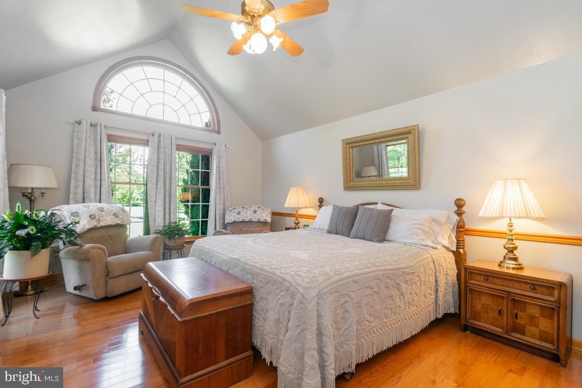 613 Hanover Pike Hampstead, MD 21074 - Photo 28 of 55 a bedroom with a bed and chandelier
