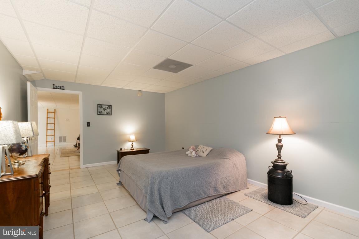 613 Hanover Pike Hampstead, MD 21074 - Photo 38 of 55 a bedroom with a bed and a lamp
