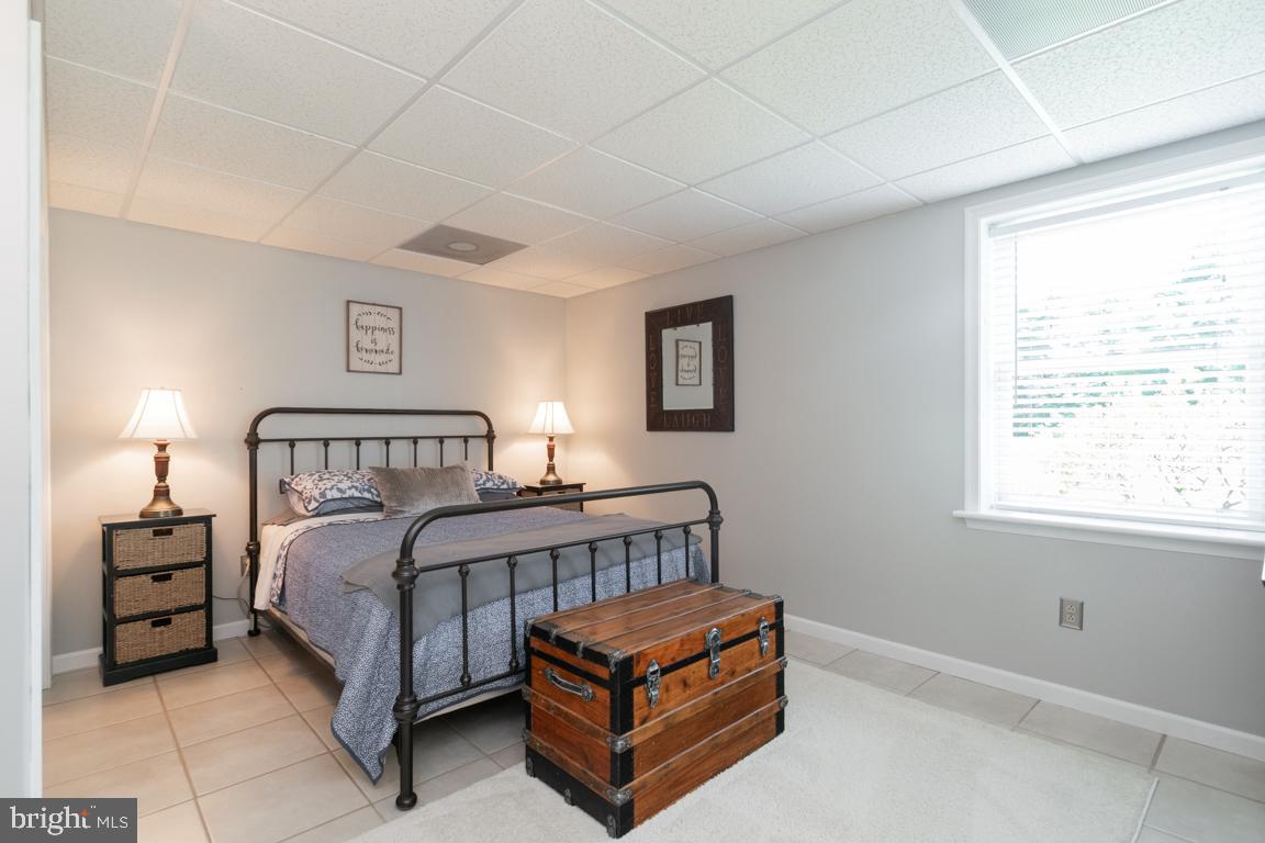 613 Hanover Pike Hampstead, MD 21074 - Photo 39 of 55 a bedroom with a bed lamp and a window