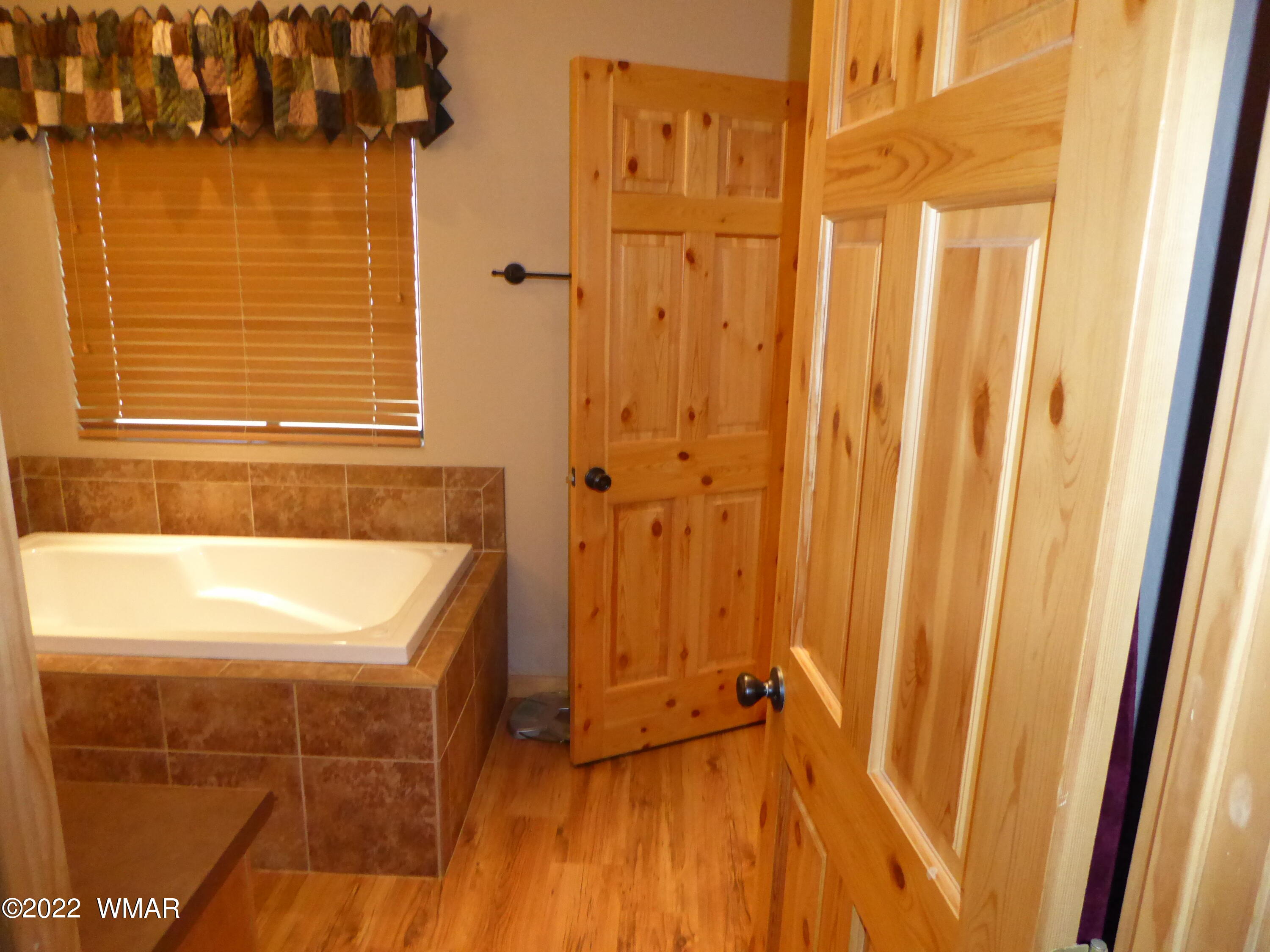 2953 Pine Rim Road Overgaard, AZ 85933 - Photo 12 of 32 a bathroom with a tub and shower