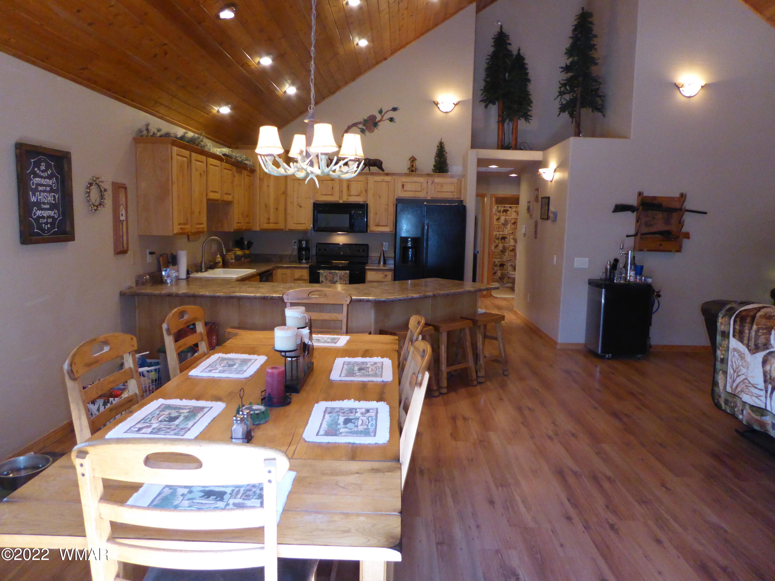 2953 Pine Rim Road Overgaard, AZ 85933 - Photo 2 of 32 a view of a dining room with furniture and wooden floor