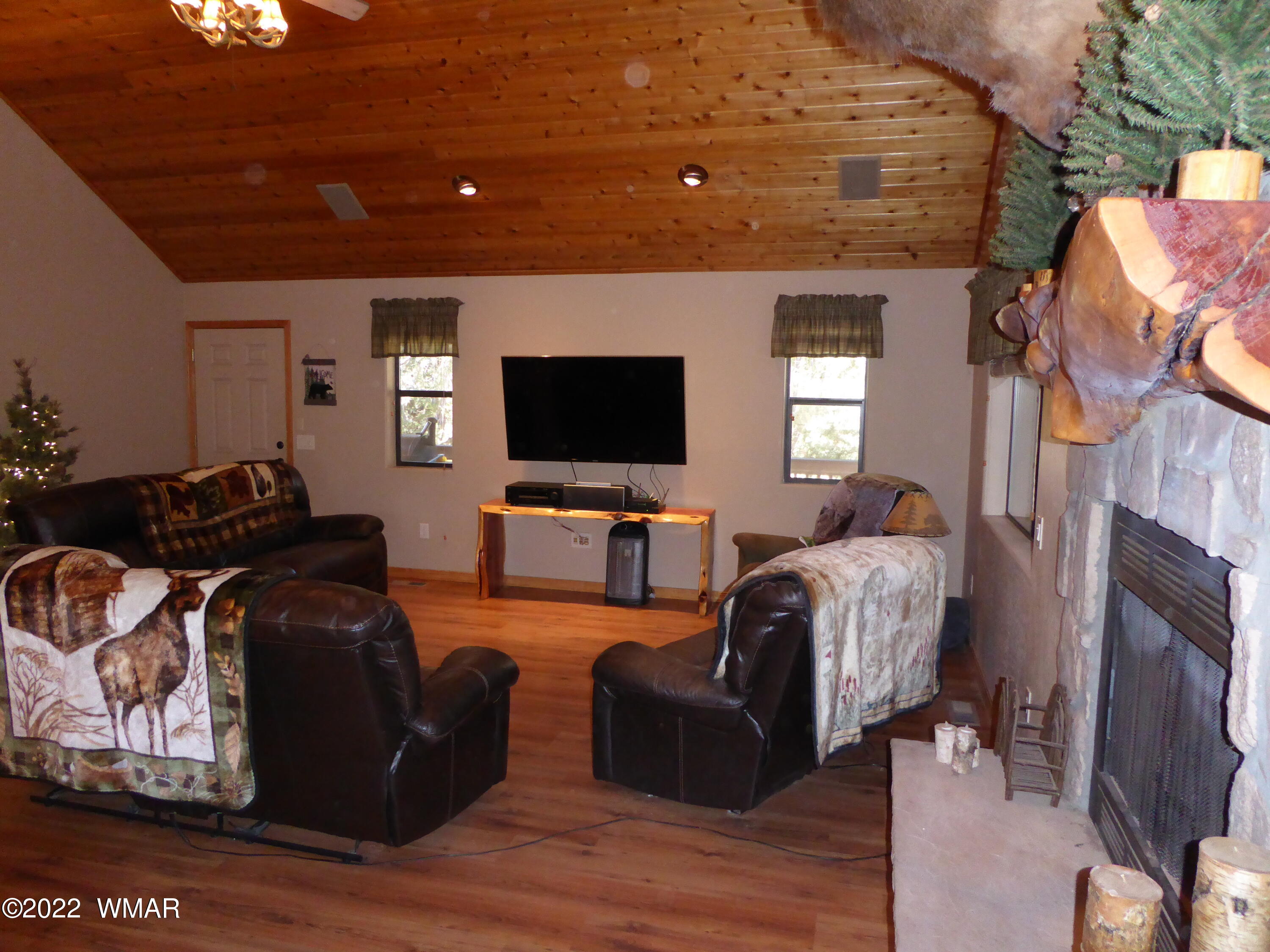 2953 Pine Rim Road Overgaard, AZ 85933 - Photo 3 of 32 a living room with furniture a flat screen tv and a fireplace