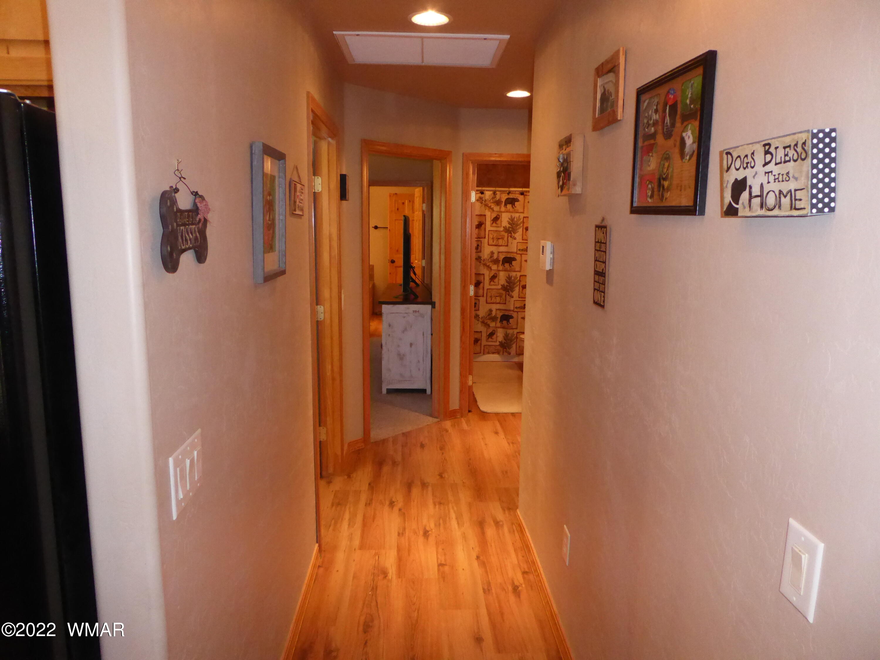 2953 Pine Rim Road Overgaard, AZ 85933 - Photo 8 of 32 a view of a hallway with wooden floor