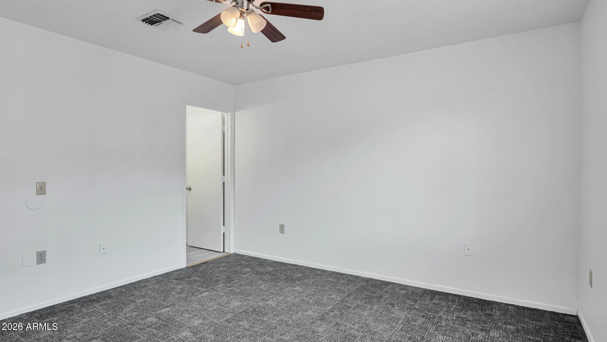 4125 North Pima Way Rimrock, AZ 86335 - Photo 9 of 14 an empty room with a chandelier fan
