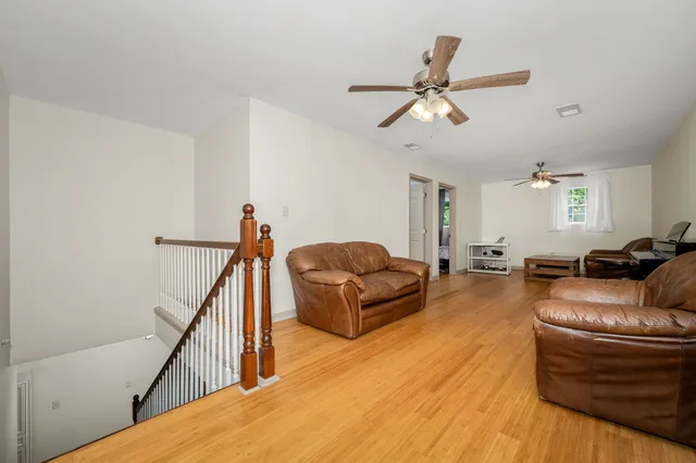 a bedroom with furniture and a wooden floor