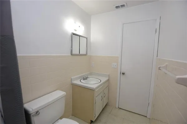 a bathroom with a toilet a sink and a mirror