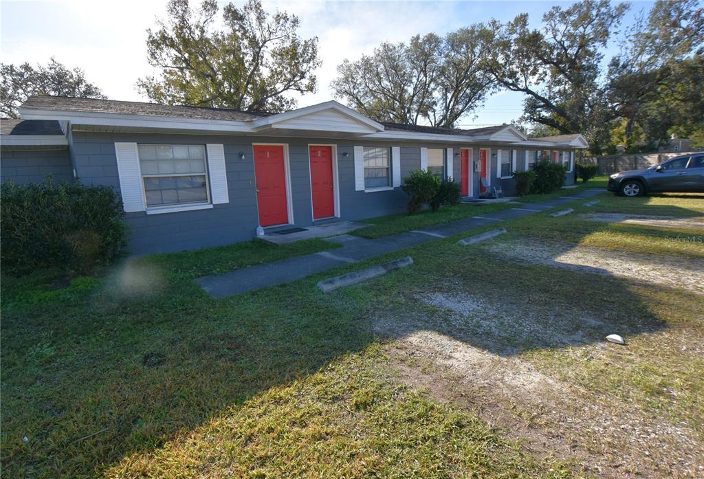 619 Robin Road, Unit 3 Lakeland, FL 33803 - Photo 16 of 17 a view of a yard in front of a house with large trees