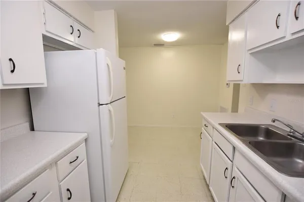 a kitchen with a sink and a refrigerator