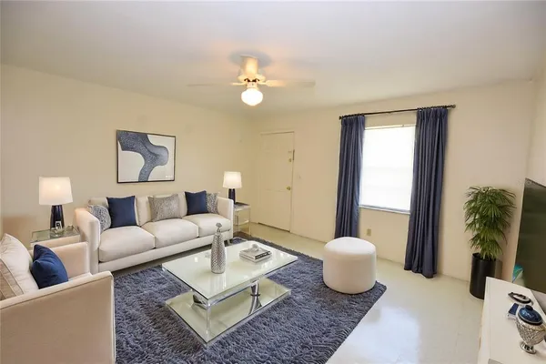 a living room with furniture and a large mirror