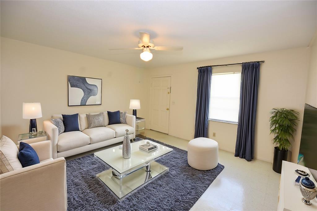619 Robin Road, Unit 3 Lakeland, FL 33803 - Photo 8 of 17 a living room with furniture and a large mirror