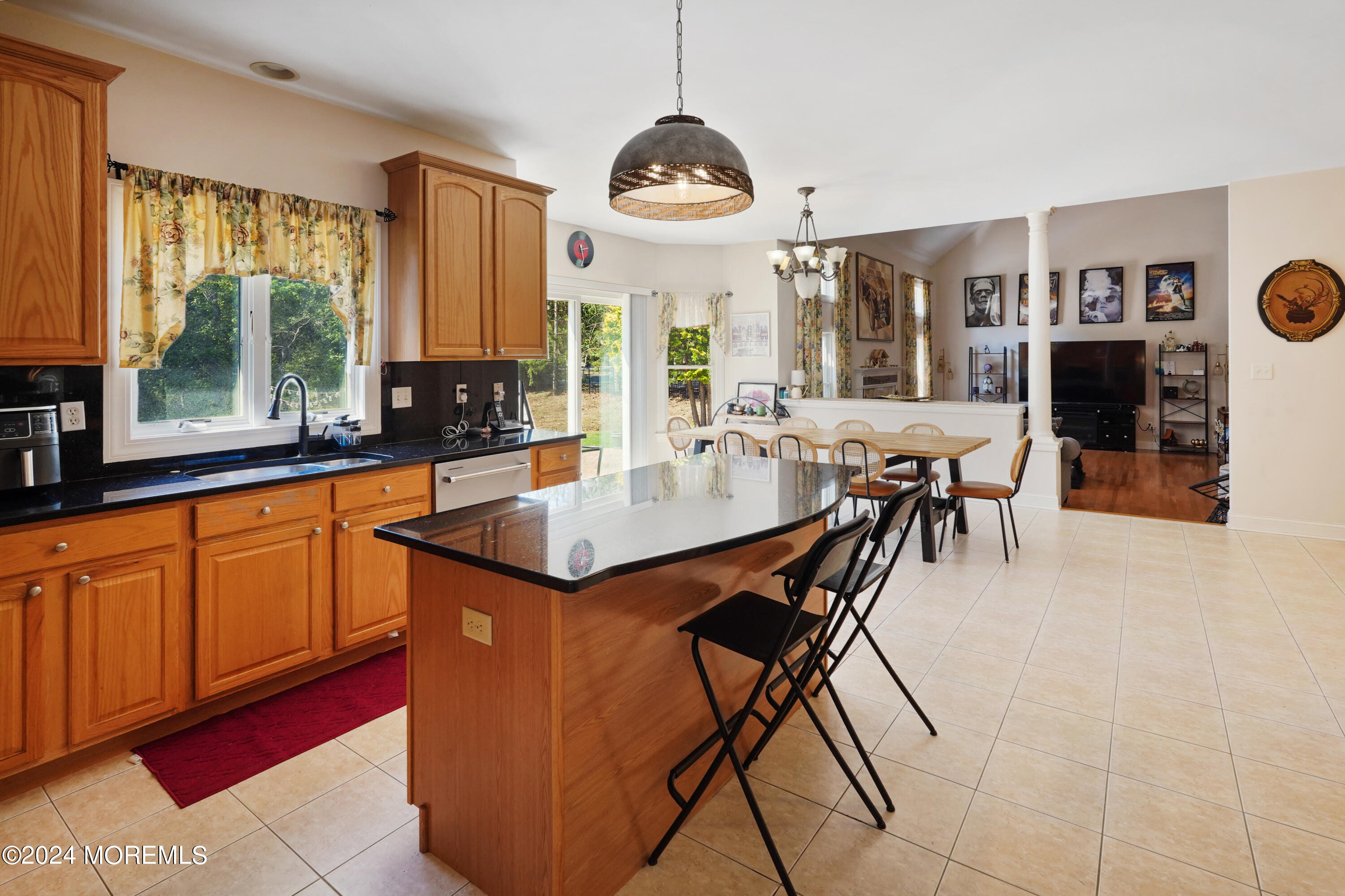 455 Iron Bridge Road Freehold, NJ 07728 - Photo 12 of 60 a dining hall with stainless steel appliances granite countertop a stove a kitchen island a dining table and chairs