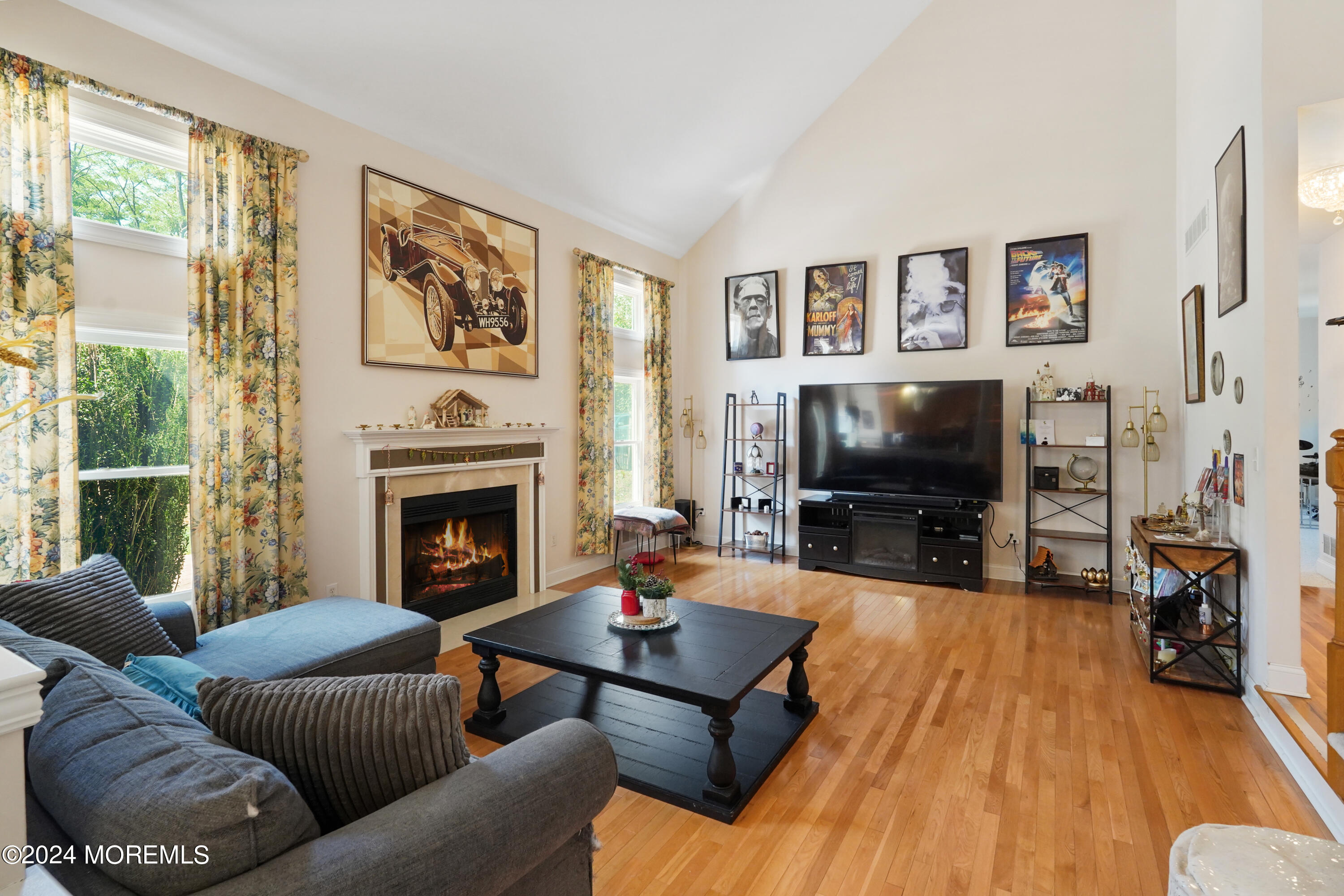 455 Iron Bridge Road Freehold, NJ 07728 - Photo 13 of 60 a living room with furniture a flat screen tv and a fireplace