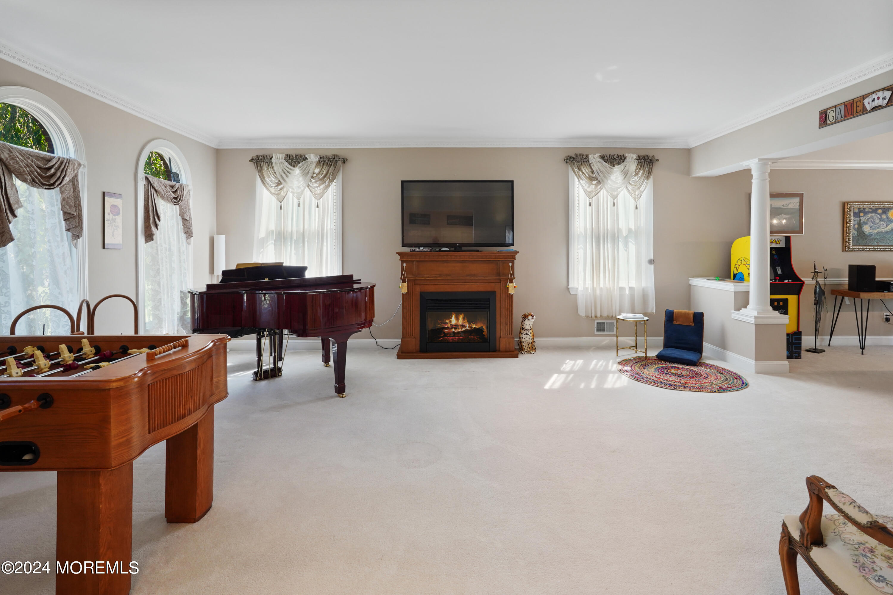455 Iron Bridge Road Freehold, NJ 07728 - Photo 16 of 60 a living room with furniture a flat screen tv and a fireplace