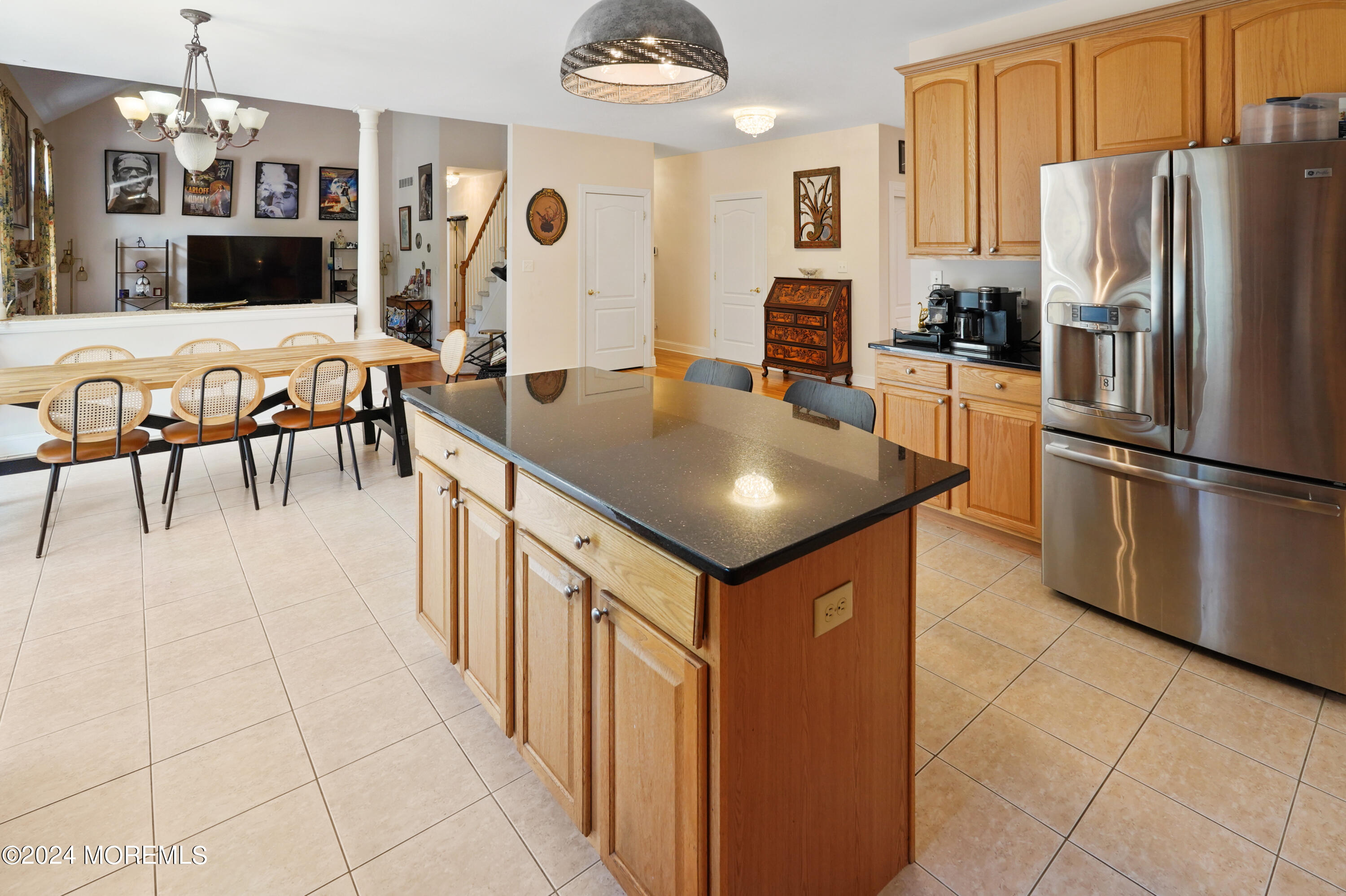 455 Iron Bridge Road Freehold, NJ 07728 - Photo 10 of 60 a kitchen with stainless steel appliances granite countertop a refrigerator a stove a sink a dining table and chairs with wooden floor