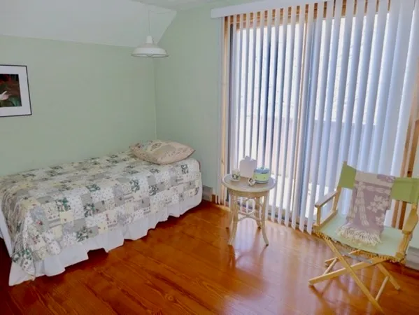 a bedroom with a bed and a chair