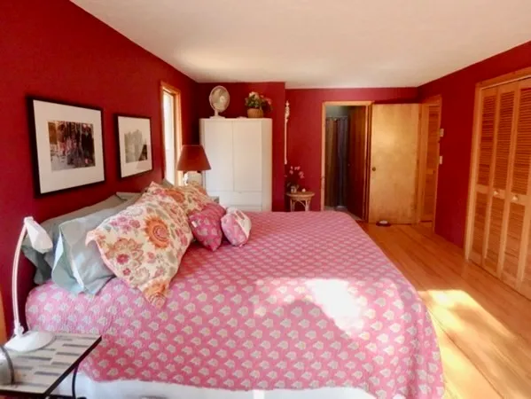 a bedroom with a large bed and a large mirror