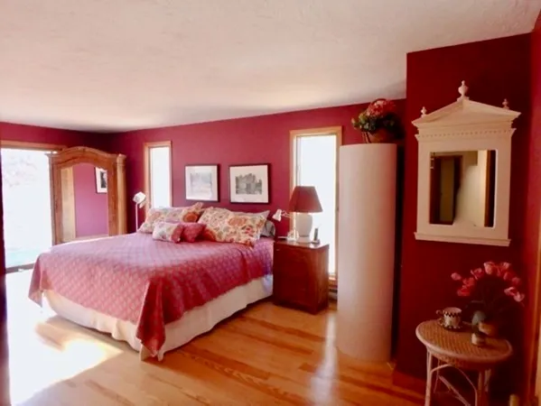 a bedroom with a bed and a lamp