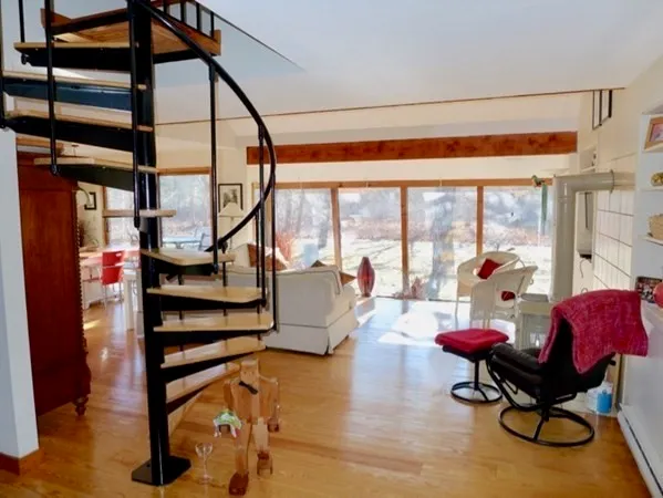 a living room with furniture and a floor to ceiling window
