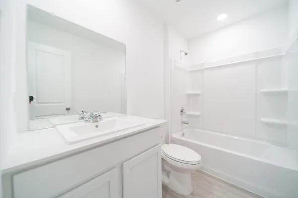 a bathroom with a sink a toilet and a bathtub
