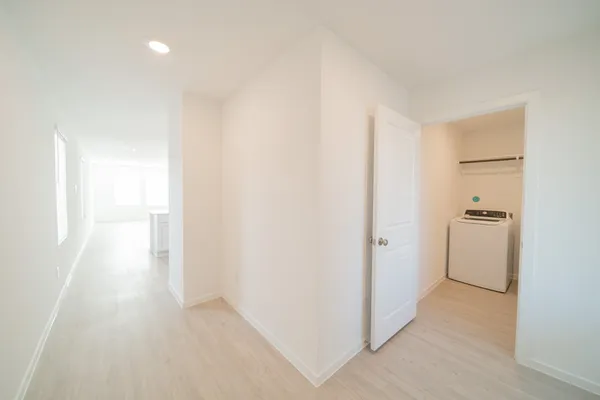 a view of a room with wooden floor