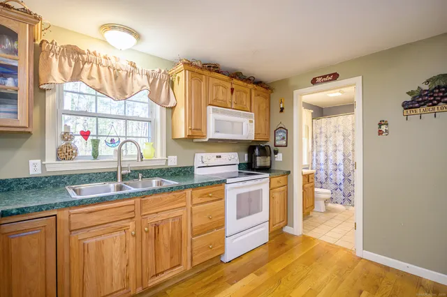 a kitchen with stainless steel appliances granite countertop a sink and cabinets