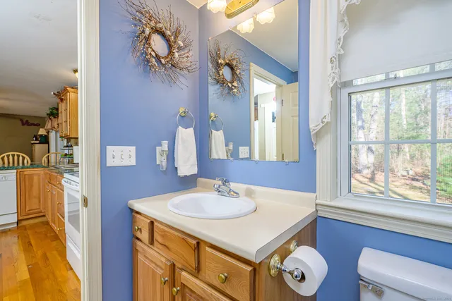 a bathroom with a sink two mirror and a window