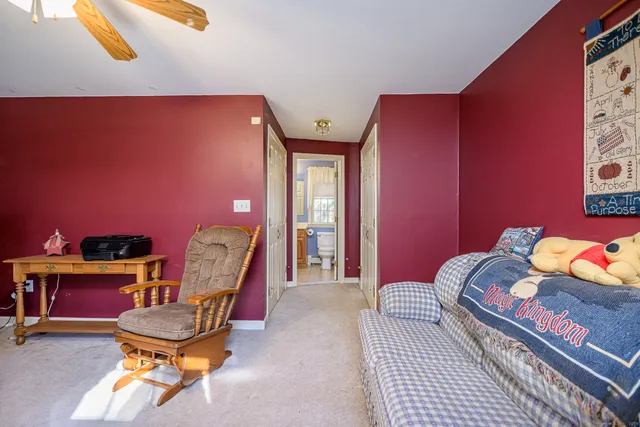 a bedroom with furniture and a chair