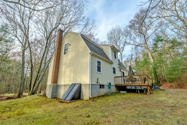 a view of a chair and table on the wooden deck