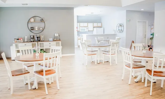 a living room with a wooden floor and white cabinets