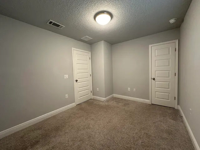 an empty room with closet area