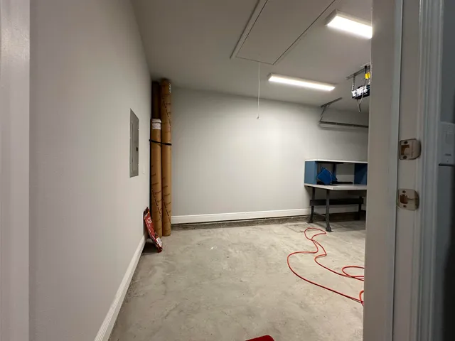 a room with gym equipment and a wooden floor