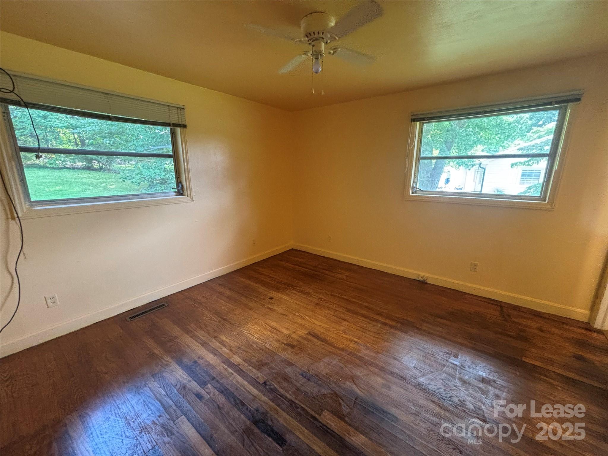 724 Oakdale Drive Statesville, NC 28677 - Photo 13 of 19 a view of an empty room with wooden floor and a window