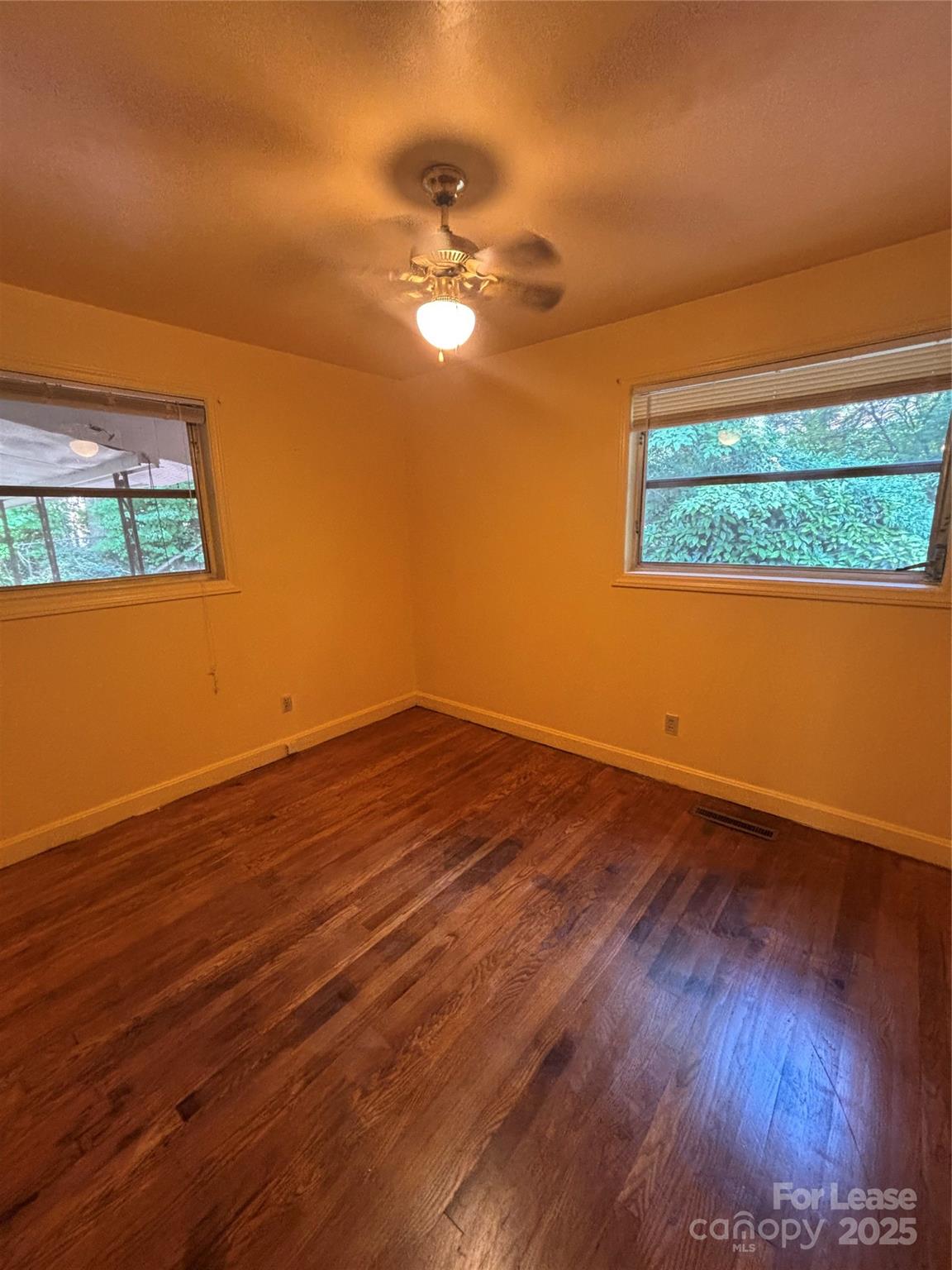 724 Oakdale Drive Statesville, NC 28677 - Photo 14 of 19 a view of a room with wooden floor and a ceiling fan