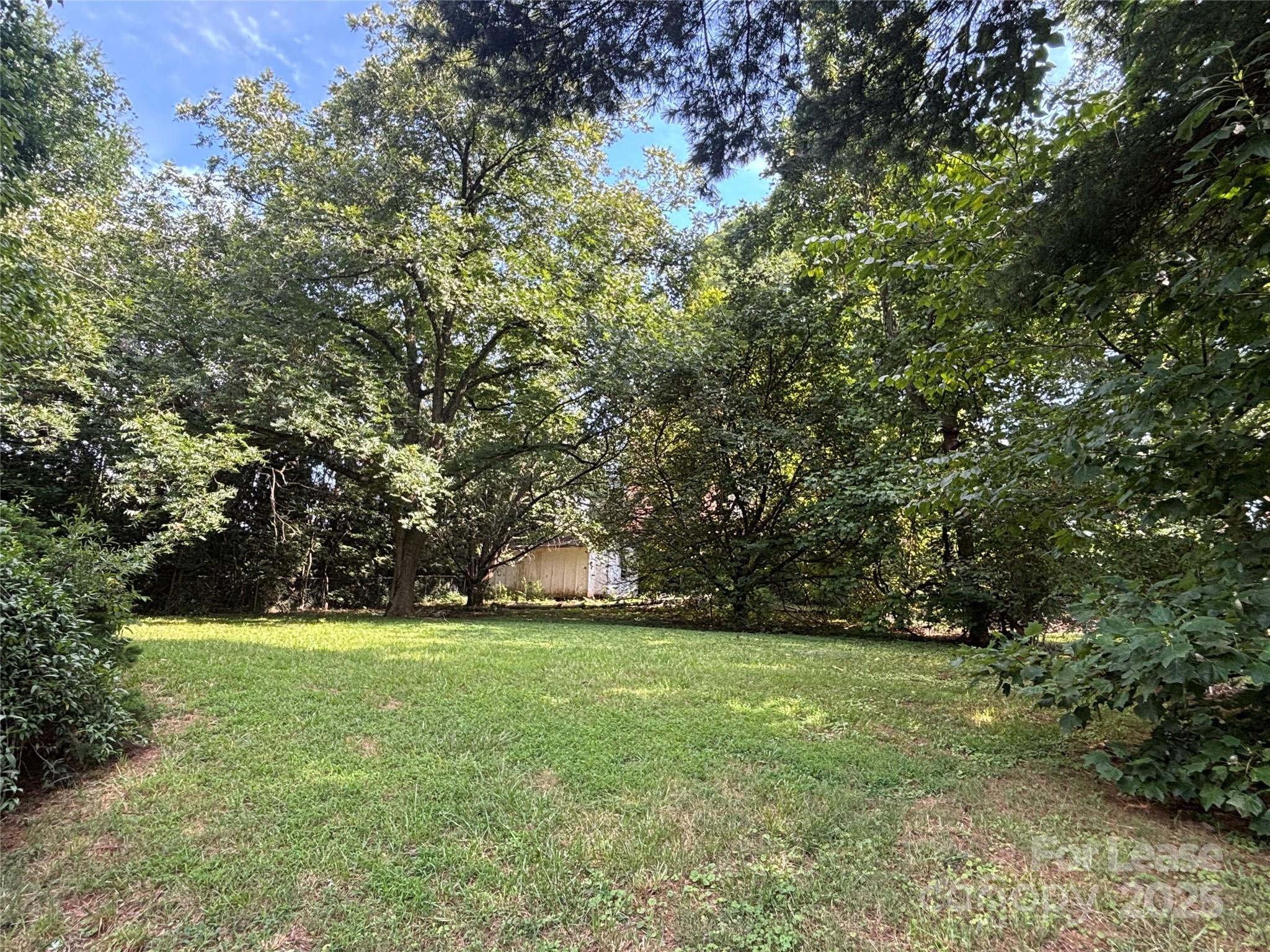 724 Oakdale Drive Statesville, NC 28677 - Photo 19 of 19 a view of outdoor space with green field and trees all around