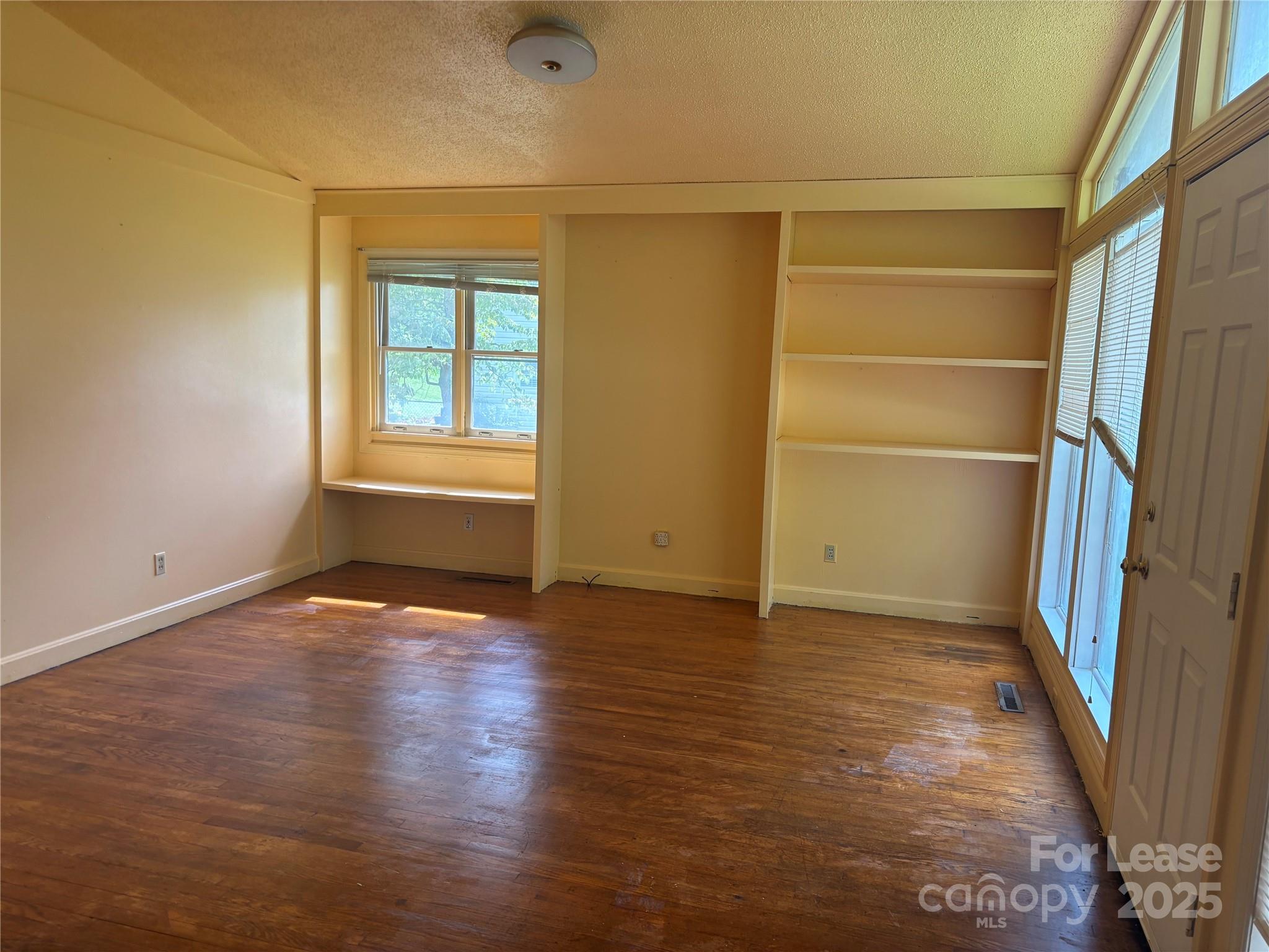 724 Oakdale Drive Statesville, NC 28677 - Photo 6 of 19 an empty room with wooden floor and windows