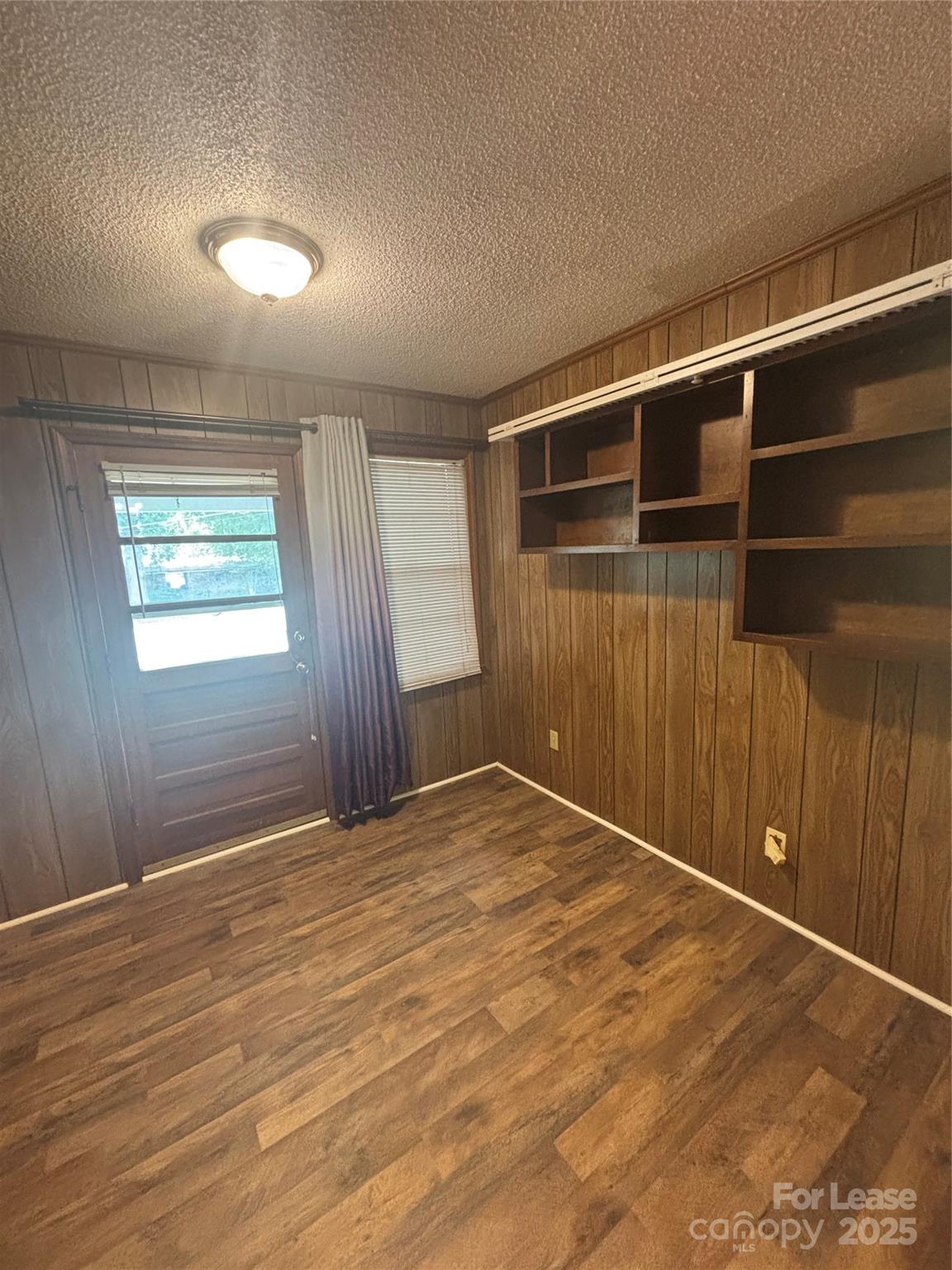724 Oakdale Drive Statesville, NC 28677 - Photo 9 of 19 a view of an empty room with wooden floor and a window