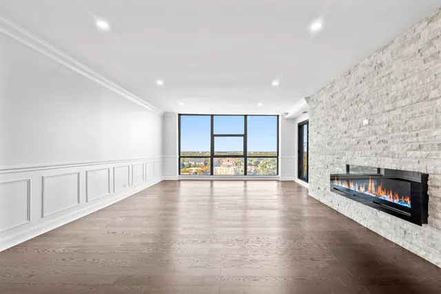 a view of an empty room with a fireplace and a window