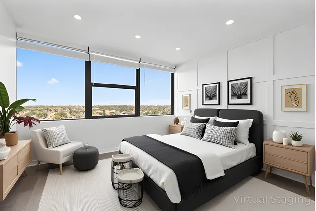 a bedroom with furniture and a large window