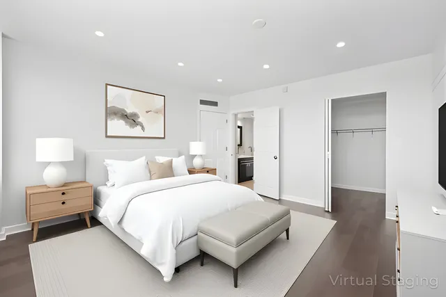 a bedroom with a bed and a painting on the wall