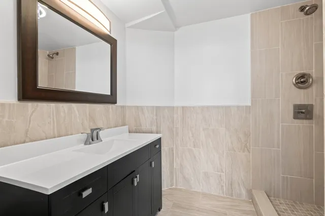 a bathroom with a sink vanity and a mirror