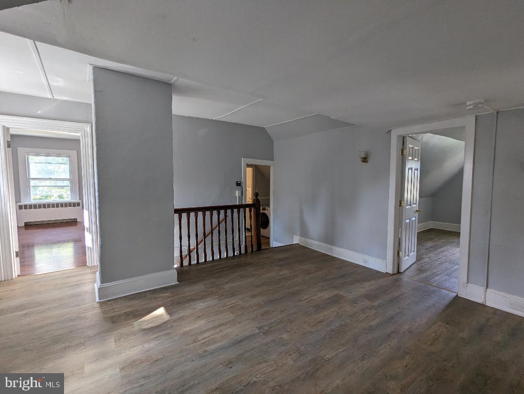 511 Evesham Avenue West, Unit A2 Magnolia, NJ 08049 - Photo 4 of 10 an empty room with wooden floor and windows
