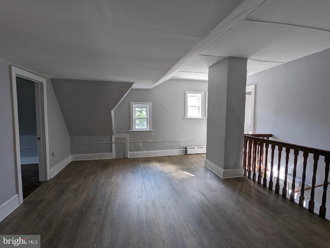 511 Evesham Avenue West, Unit A2 Magnolia, NJ 08049 - Photo 5 of 10 an empty room with wooden floor and windows