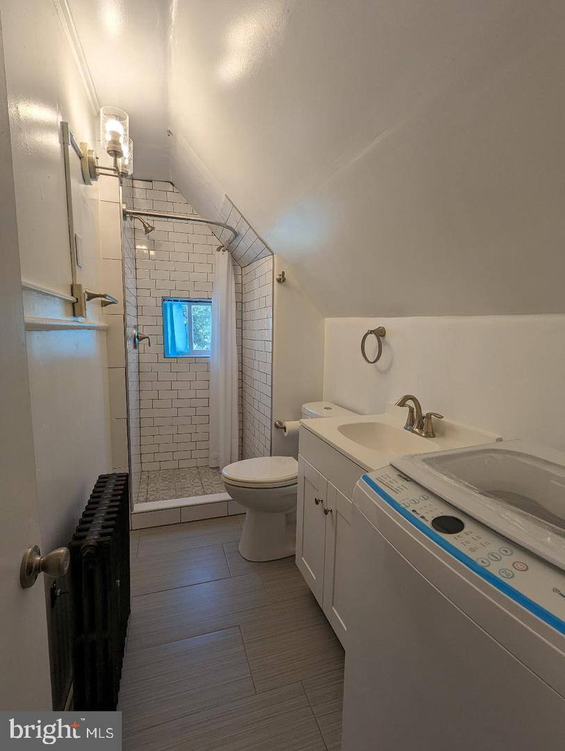 511 Evesham Avenue West, Unit A2 Magnolia, NJ 08049 - Photo 6 of 10 a bathroom with a granite countertop sink a toilet and shower