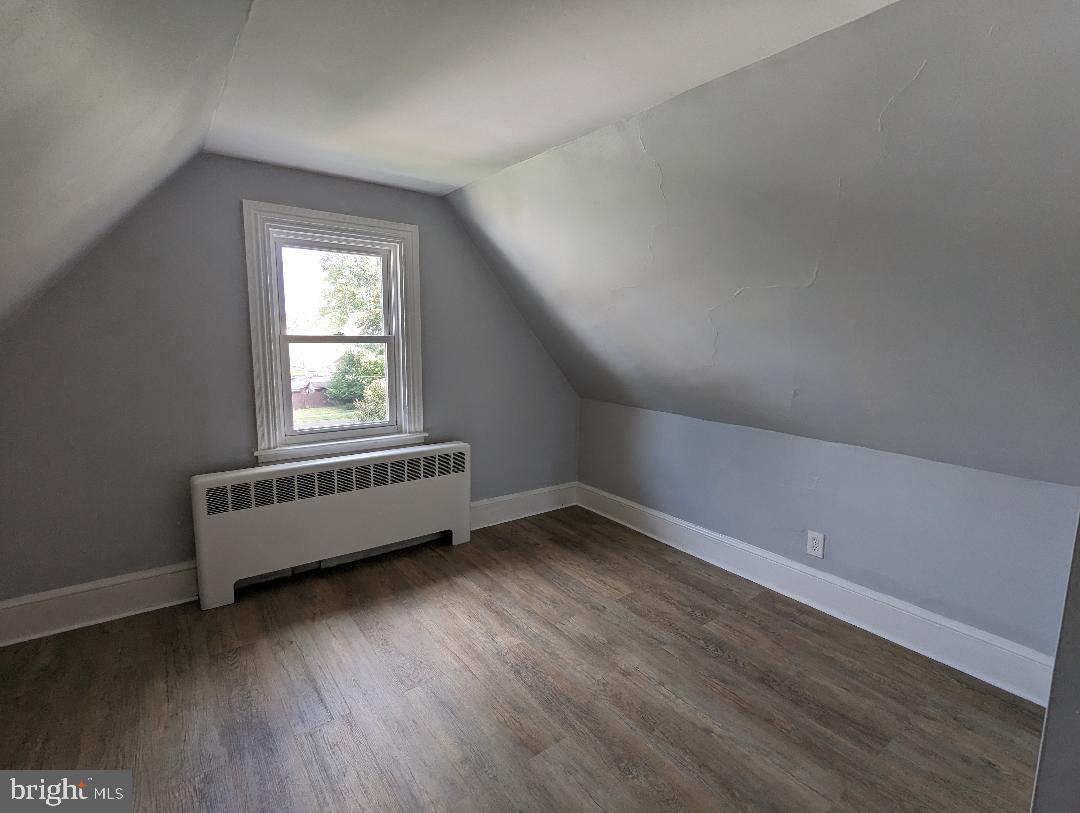 511 Evesham Avenue West, Unit A2 Magnolia, NJ 08049 - Photo 7 of 10 an empty room with wooden floor and windows