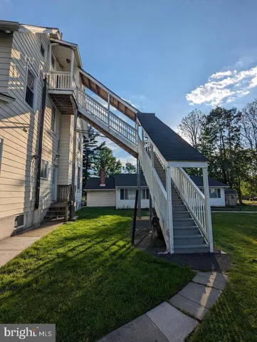 a view of a house with backyard and deck