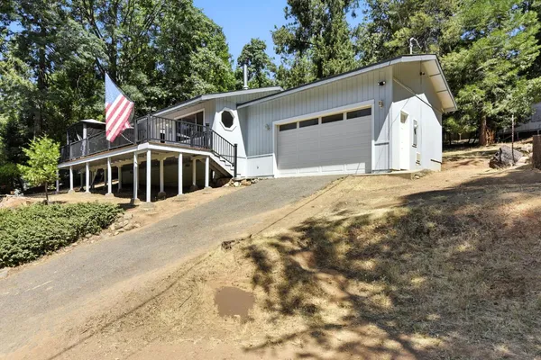 a view of a white house with a yard