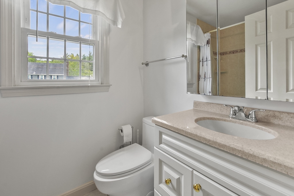 187 Eaton Road Framingham, MA 01701 - Photo 32 of 41 a bathroom with a granite countertop toilet sink and mirror